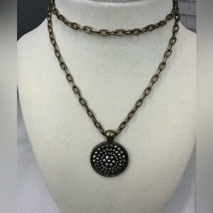 Antique gold tone chunky long chain with dark silver tone pendant